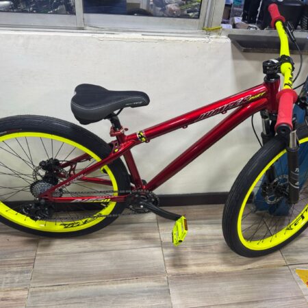 Red Jumper Stunt on-trail bike with yellow rims and accents.