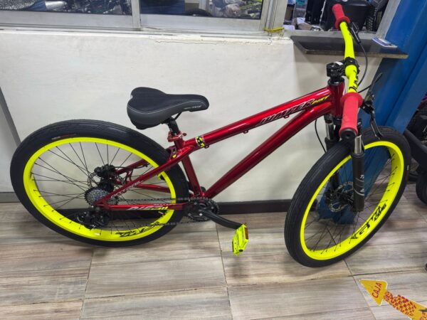 Red Jumper Stunt on-trail bike with yellow rims and accents.