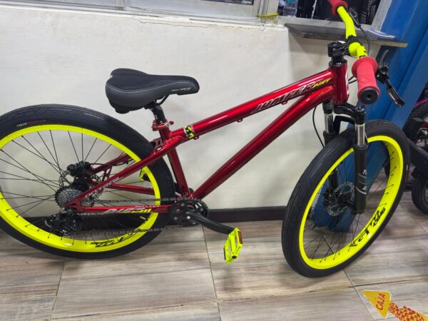 Red ON TRAIL JUMPER STUNT bike with yellow rims, handlebars, and pedals.